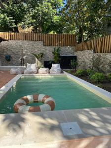 a small swimming pool with a lifebuoy in a backyard at Refúgio da Caniçada - T4, Piscina Aquecida Gerês in Geres