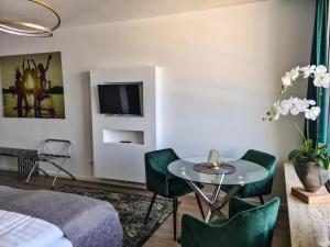 a bedroom with a bed and a table and chairs at Rheinblick Apartments in Cologne