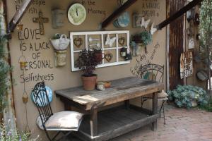 a room with a table and chairs and a wall with signs at The Yardt Guest House in Trichardt