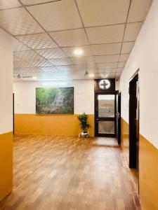 an empty room with a clock on the wall and a door at HOTEL SHIVIKA in Bikaner