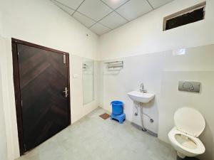 a bathroom with a toilet and a sink at HOTEL SHIVIKA in Bikaner +60 photos