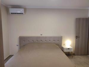 a bedroom with a large bed with a light on it at Lena Studios in Sidari