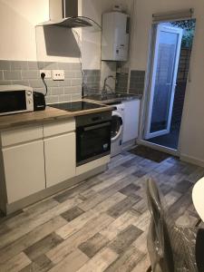 a kitchen with a sink and a stove top oven at Kasu Lodge - Radford, Nottingham in Nottingham