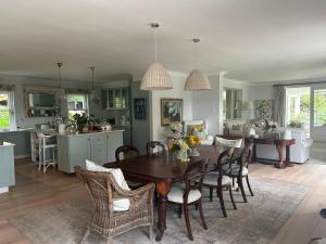a kitchen and dining room with a table and chairs at Camberley Wines - Luxury Accommodation in Stellenbosch