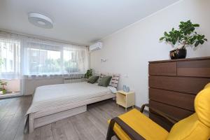 a bedroom with a bed and a window at Algirdo Apartments, Self Check-in, Free Private Parking in Vilnius