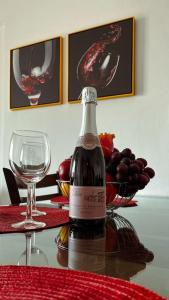 a bottle of wine sitting on top of a table at Sea Breeze Apartment in Paphos City