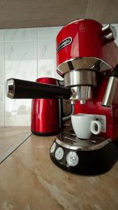 a red mixer sitting on top of a counter at Sea Breeze Apartment in Paphos City
