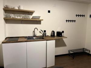 a kitchen with a sink and a counter top at Gudauri - Apartment - Sleeps 4 - Pool - Parking in Gudauri