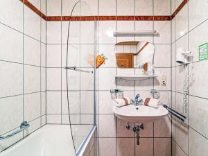 a bathroom with a sink and a shower and a tub at Apartment Panorama by Interhome in See