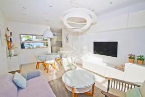 a living room with a couch and a table at Le Copacabana Riviera in Nice