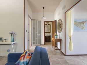 a living room with a blue couch and a bathroom at Holiday Home Norbert by Interhome in Siracusa +48 photos