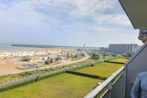 a view of the beach from the balcony of a condo at Sea Side Calais vue mer in Calais