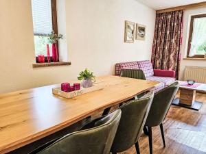 a dining room with a wooden table and chairs at Apartment Inn by Interhome in See +67 photos