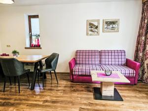 a living room with a couch and a table at Apartment Inn by Interhome in See
