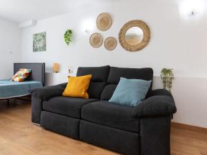 un sofá negro sentado en una sala de estar en Studio Beach La Pineda by Interhome, en La Pineda