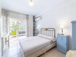 a bedroom with a bed with a blue dresser and a window at Apartment Navio by Interhome in Aguadulce