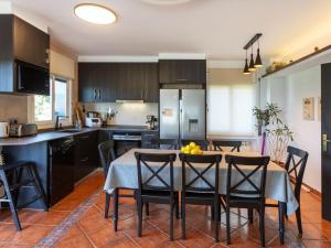 a kitchen and dining room with a table and chairs at Holiday Home Can Pau by Interhome in Maçanet de la Selva +21 photos