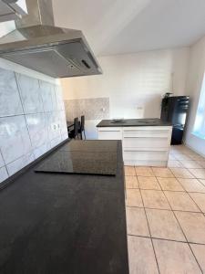 a kitchen with a stove and a counter top at Altbauapartment in Wassernähe und Magenta TV in Brandenburg an der Havel +9 photos