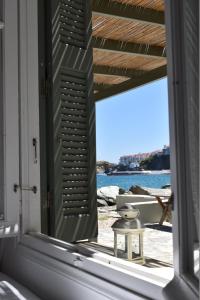 a window in a room with a view of the ocean at Thalassa3 in Andros +7 photos