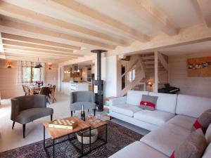 a living room with a couch and a table at Chalet Chalet Domino by Interhome in Chesières