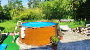 a pool in a backyard with a table and a bench at Sleeps 18 - Lakeview - House - Vonyarcvashegy in Vonyarcvashegy +3 photos