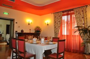 a dining room table with a white tablecloth and chairs at Camere al Borgo in Forchia