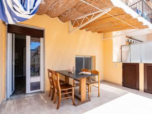 a dining room with a table and chairs at Apartment Nives by Interhome in Diano Marina