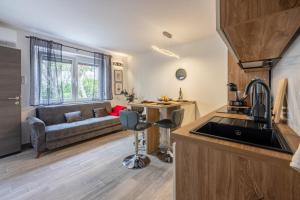 a kitchen and living room with a couch at Nika in Crikvenica