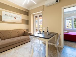 a living room with a couch and a table and chairs at Apartment Nives by Interhome in Diano Marina