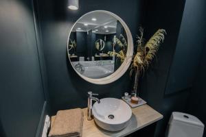 a bathroom with a sink and a mirror at WOODkz in Oral +6 photos
