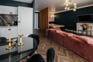 a living room with a couch and a glass table at WOODkz in Oral