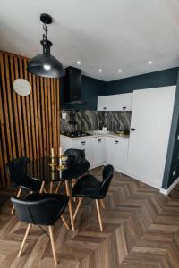 a kitchen with a table and chairs in a kitchen at WOODkz in Oral