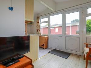 a kitchen with a large sliding glass door at Constantine Bay in Padstow