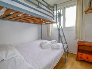 a bedroom with a bunk bed with two towels on it at Constantine Bay in Padstow