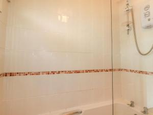 a bathroom with a shower and a bath tub at Constantine Bay in Padstow