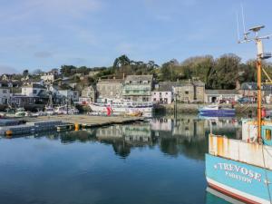 a boat docked in a marina with a town at Constantine Bay in Padstow