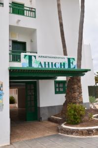 a building with a sign for an apartment building at App Tahiche, Encanto Canario in Costa Teguise