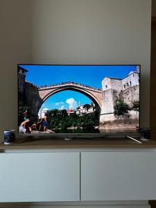 a flat screen tv sitting on top of a dresser at Apartment Ivan in Mostar