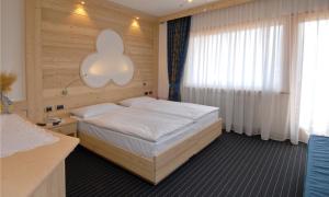 Posteľ alebo postele v izbe v ubytovaní Hotel Flora Alpina + 31 fotografií