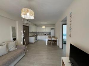 a living room and kitchen with a couch and a table at Sea Star in Nikiti
