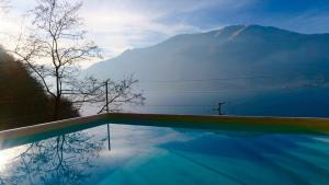 a swimming pool with a view of a mountain at Residence Dorio in Dorio