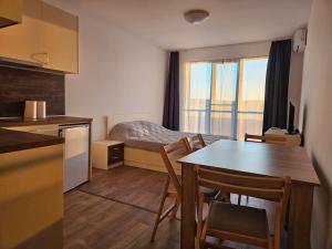 a kitchen and a bedroom with a bed and a table at Sunset studio in Shartrez in Shkorpilovtsi