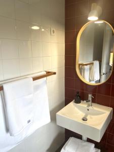 a bathroom with a sink and a mirror and towels at El Encanto de Bustares in Bustares +17 photos