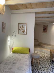a bedroom with a bed and a stool and a table at Torre Anna Red in Riomaggiore