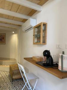 a kitchen with a counter and a chair in a room at Torre Anna Red in Riomaggiore