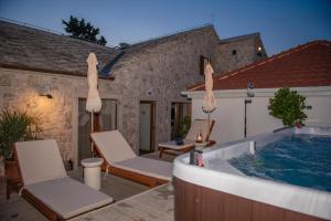 a patio with a jacuzzi tub in a house at Integra Hotel in Trebinje