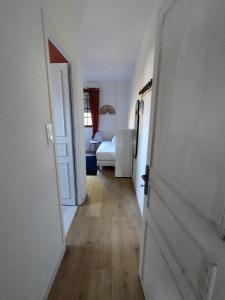 a hallway with an open door to a bedroom at Au Pti' Bonheur in Saint-Coulomb