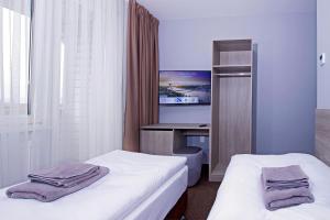 Posteľ alebo postele v izbe v ubytovaní Aviator Garni Hotel Bratislava