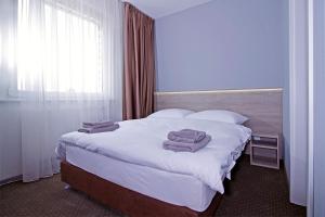 Posteľ alebo postele v izbe v ubytovaní Aviator Garni Hotel Bratislava