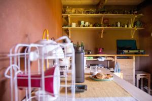 a kitchen with a table with a plate of food at Deda Vinko Off Grid Cabin in Ključ